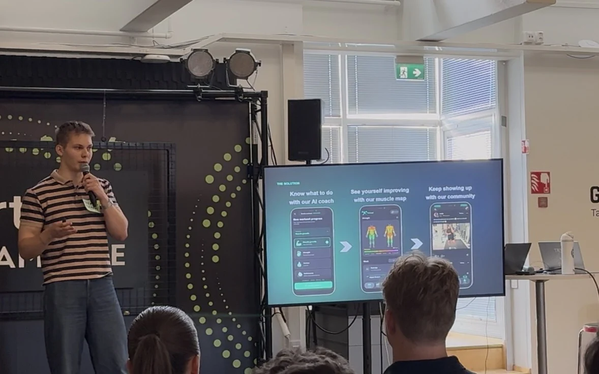 Tsemp pitching at the TRES Demo Day in Tampere, with the app's AI coach, muscle map and community on screen